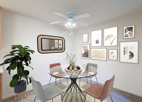 A living room with a glass table surrounded by chairs and pictures on the wall at Cherrywood Apartments, California