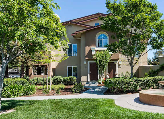 A house with a fountain in front of it at The Woods Apartments, San Jose