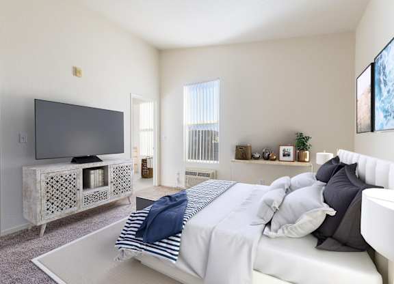 A bedroom with a bed, a television, and a window with blinds at The Woods Apartments, San Jose, 95136