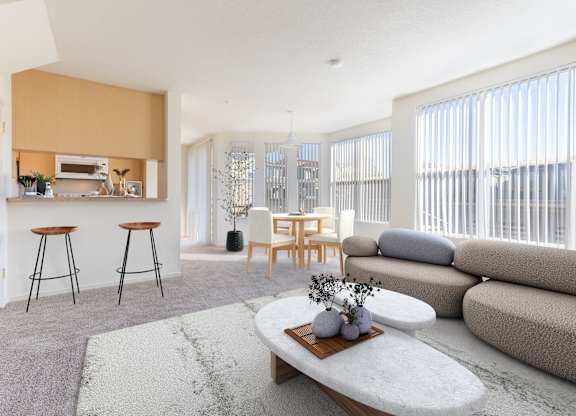 A modern living room with a bar area and a grey sofa.