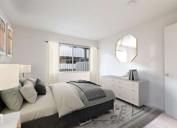 A bedroom with a bed, dresser, and mirror at The Woods Apartments, San Jose, CA, 95136
