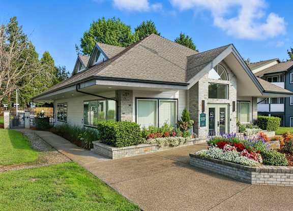 A house with a grey roof and a white front porch.
