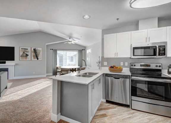 Stainless-Steel Appliances with Quartz Countertops and White Cabinets at Clock Tower Village, DuPont, WA