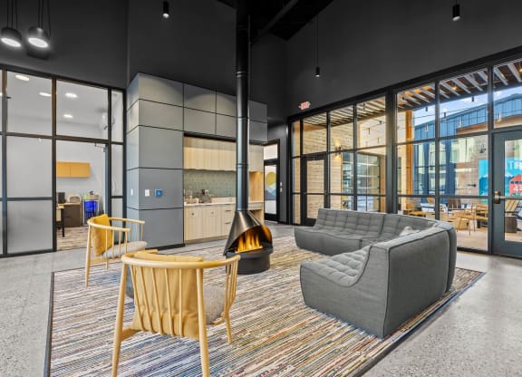 a living room with couches chairs and a fireplace