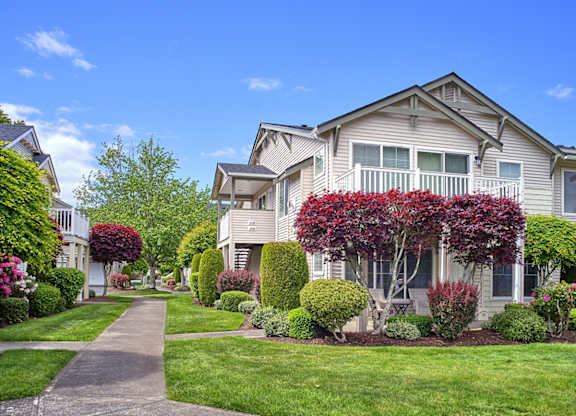 community exterior with lush landscaping and side walks at Clock Tower Village, DuPont