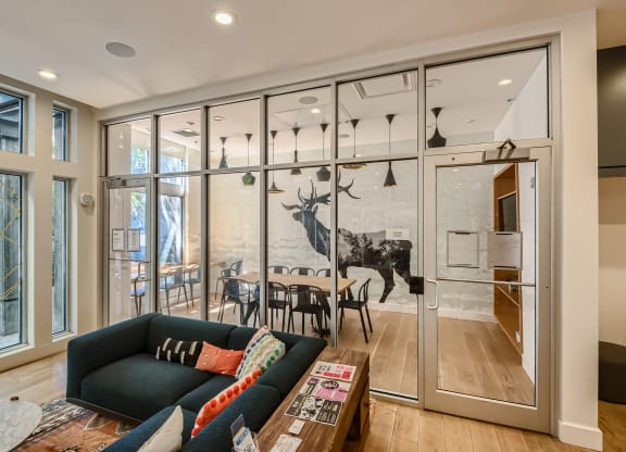 a wall of glass separates the kitchen from the living room