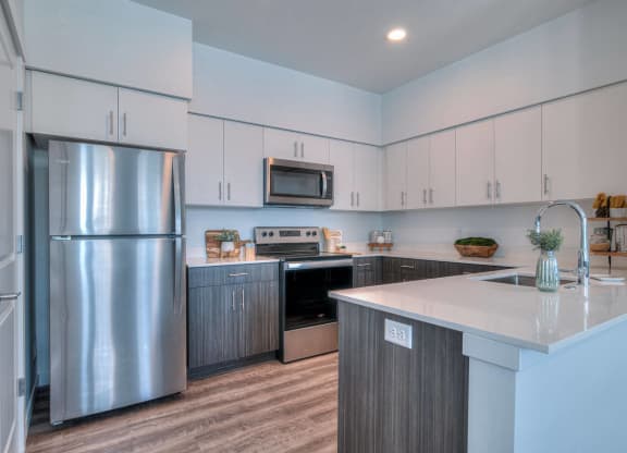 a kitchen with stainless steel appliances and white cabinets