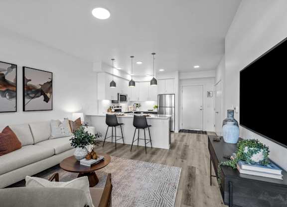 an open living room and kitchen with a couch and a table