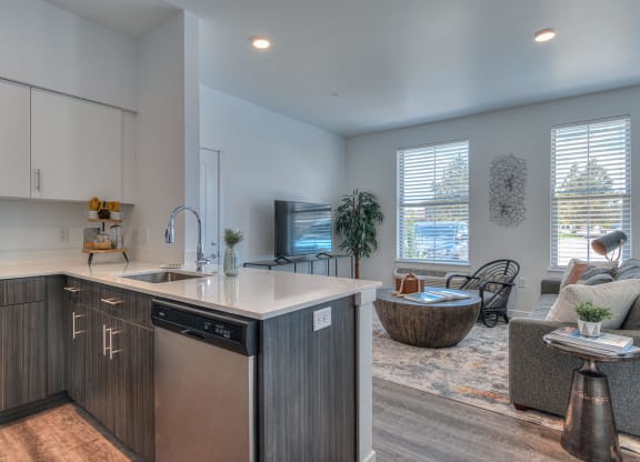 a kitchen with an island and a living room with a couch