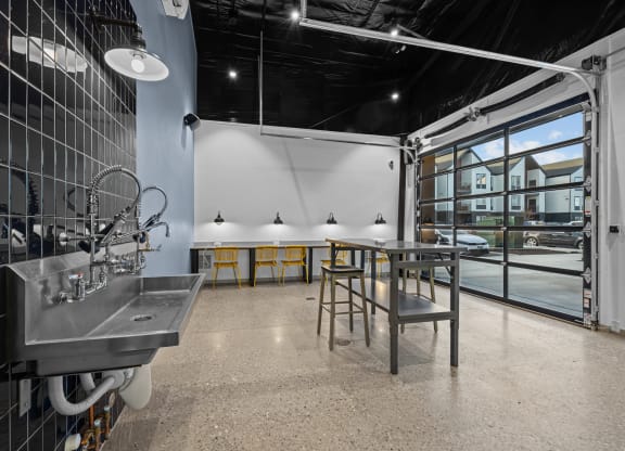 a tasting room with a table and chairs and a large window