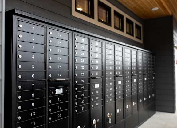 A set of black mailboxes with numbers 1 to 31 on them.