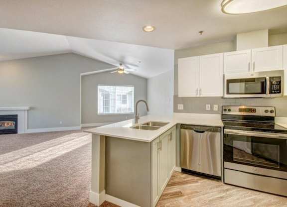 kitchen with stainless steel appliances and double sinks at Clock Tower Village, DuPont