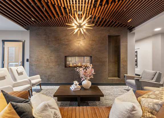 a living room with couches and chairs and a fireplace