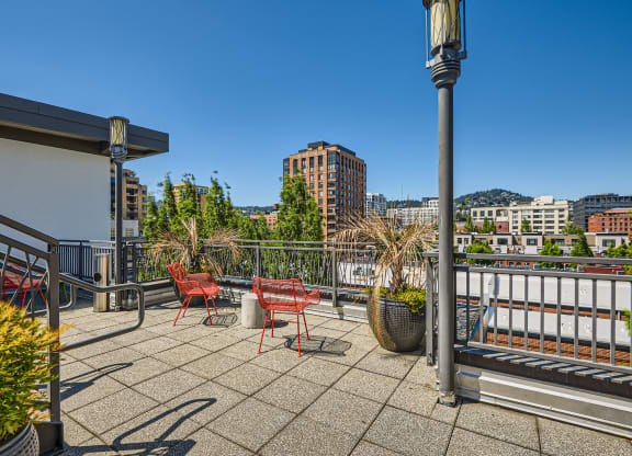 views of the city from the rooftop terrace of a building at the ace apartments