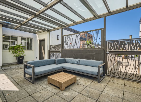a living room with a couch and a coffee table on a patio