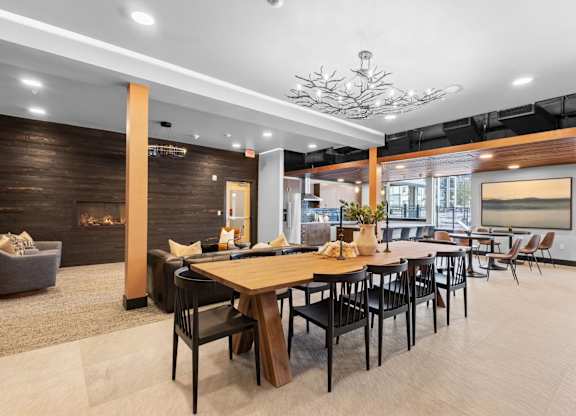 a dining area with tables and chairs and a fireplace