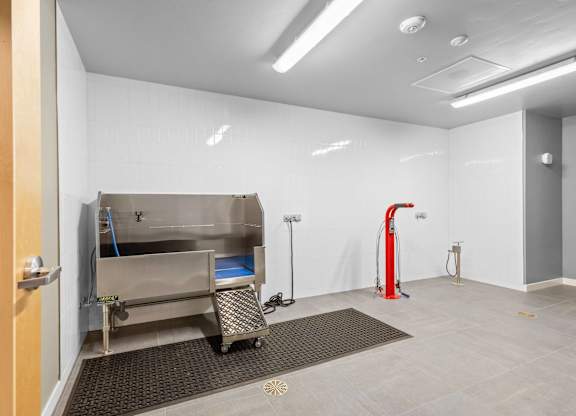 a room with a stainless steel stove and a red
