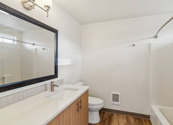 A white sink with a mirror above it in a bathroom.