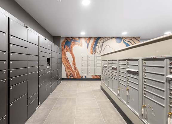 the locker room at the gym has lockers and a mural