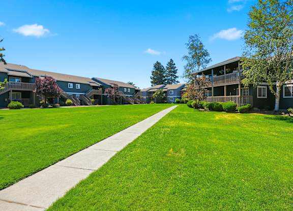 A sunny day at a residential area with houses and green lawns.