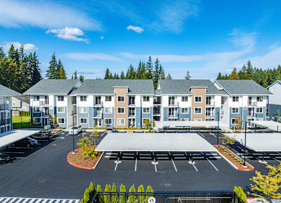 A large building with a parking lot in front of it.