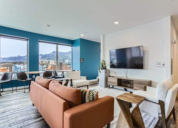 A living room with a brown couch and a television.