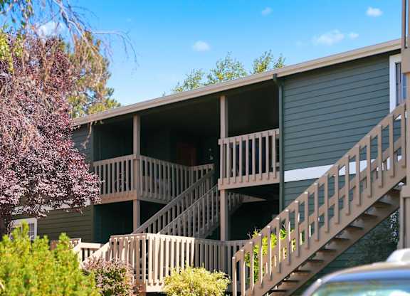 A building with a balcony and stairs.