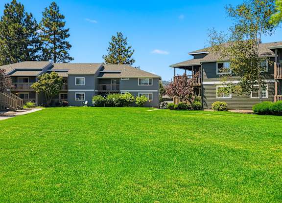 A grassy area in front of two houses.