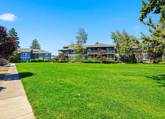 A grassy area with a building in the background.