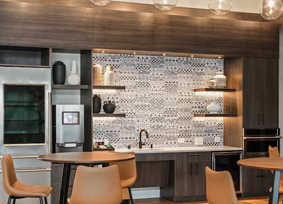 A modern kitchen with a wooden table and chairs.