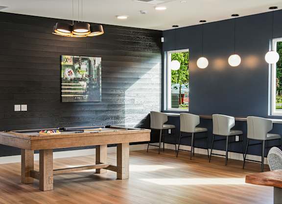 A dining room with a wooden table and chairs.