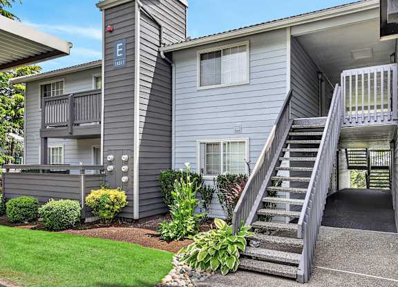 Apartment complex with a staircase leading to the second floor.