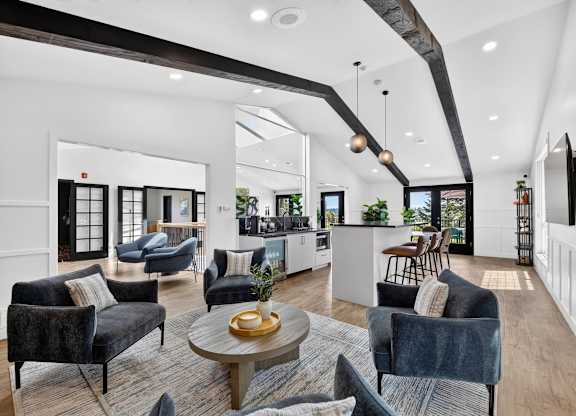 A modern living room with a dark grey sofa and a wooden coffee table.