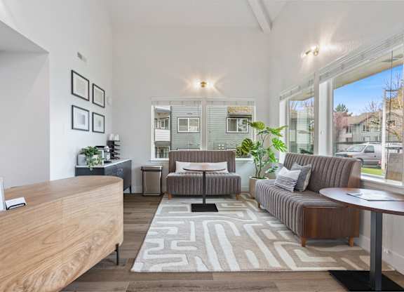 A well-lit living room with a couch, chair, and coffee table.