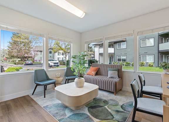 A living room with a couch, chairs, and a coffee table.