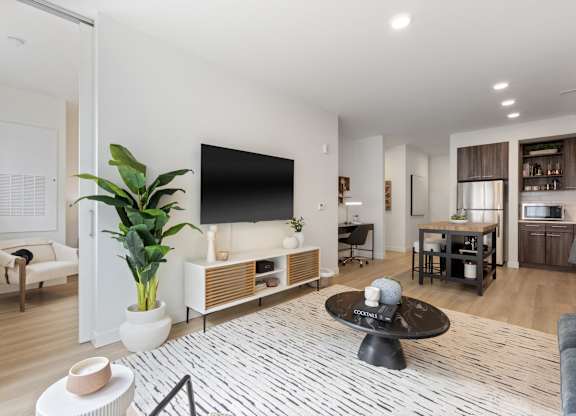 A modern living room with a flat screen TV and a coffee table.