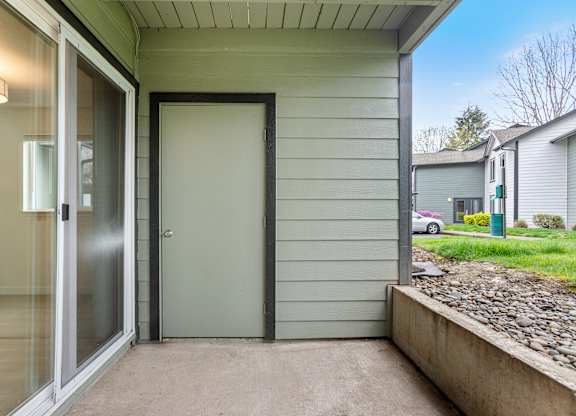 A grey door is closed with a black frame.