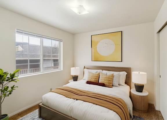 A bedroom with a large bed and a painting above it.