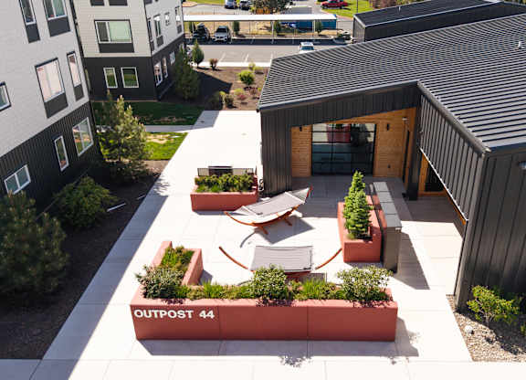 A modern building with a black roof and a sign that says