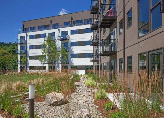 A modern building with a garden in front.