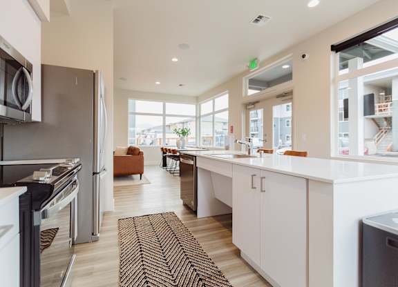 A modern kitchen with white cabinets and a large island.