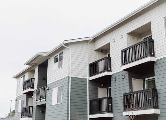 Apartment building with balconies and doors.