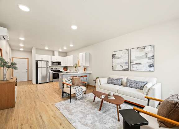 A modern living room with a white couch and a wooden coffee table.