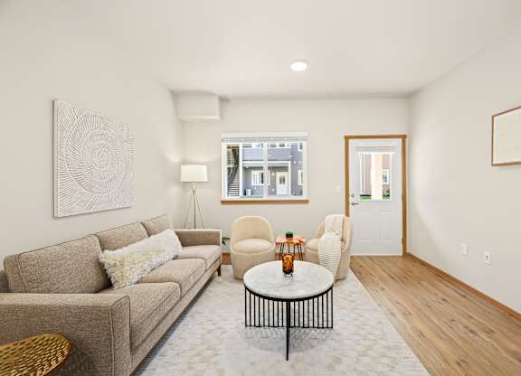 A living room with a couch, chair, and coffee table.