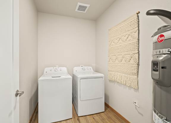 A laundry room with a washer and dryer and a washing machine.