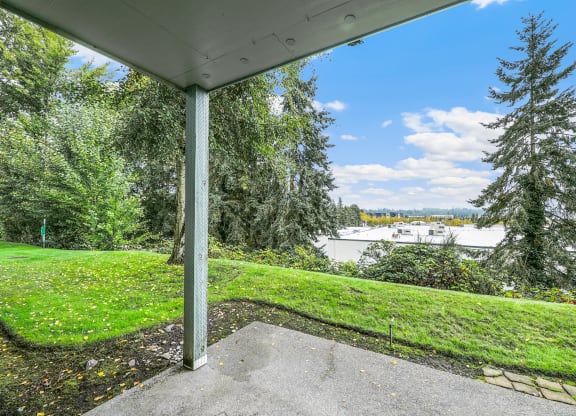 a porch with a view of a lake and trees
