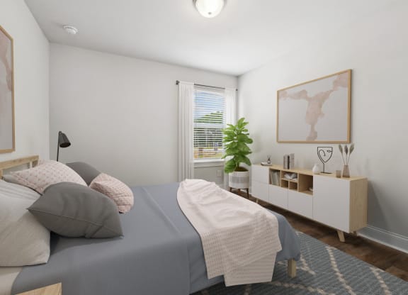 a bedroom with white walls and a bed with gray sheets and pillows