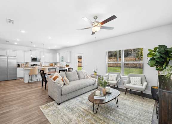 A modern living room with a grey couch and a coffee table.