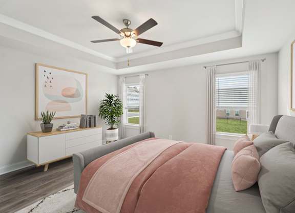Primary bedroom with ceiling fan and attached bathroom.