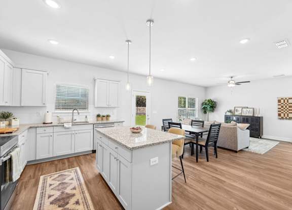 A kitchen with a table and chairs in the middle of the room.